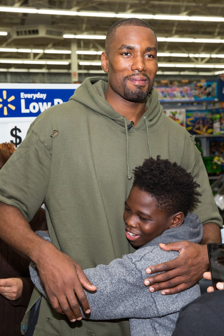 OKC Thunder F Serge Ibaka gets a hug from a child he helped out. Photo courtesy of Zach Beeker of OKC Thunder. 
